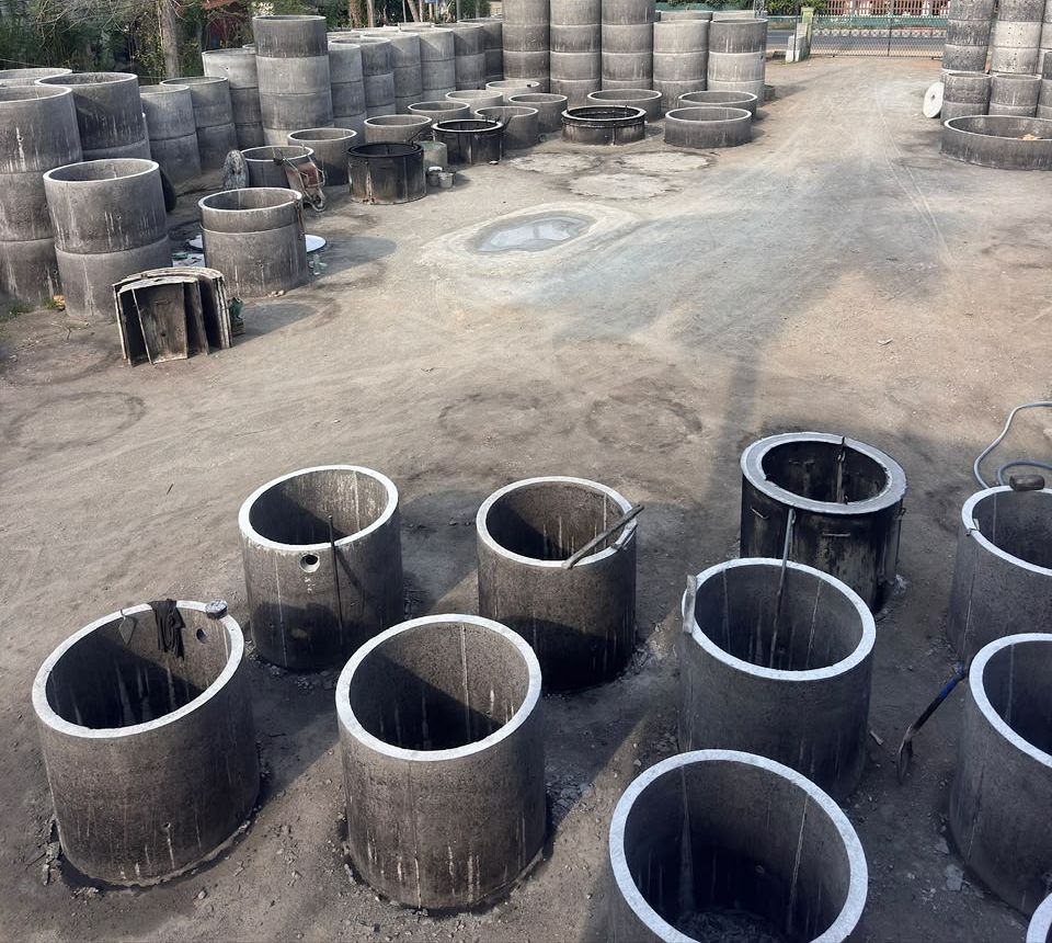 Steel moulds filled with fresh concrete standing in rows on the casting floor