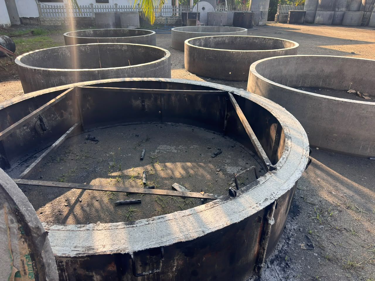 A large concrete ring still held in its braced steel mould